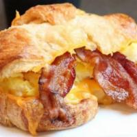 Southern Charm Breakfast Sandwich · Scrambled eggs, bacon, and cheddar cheese on a croissant.