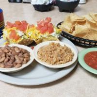 Monday'S Only Tacos  · Three beef tacos topped with lettuce, tomatoes, and cheddar cheese, rice and pinto beans and...