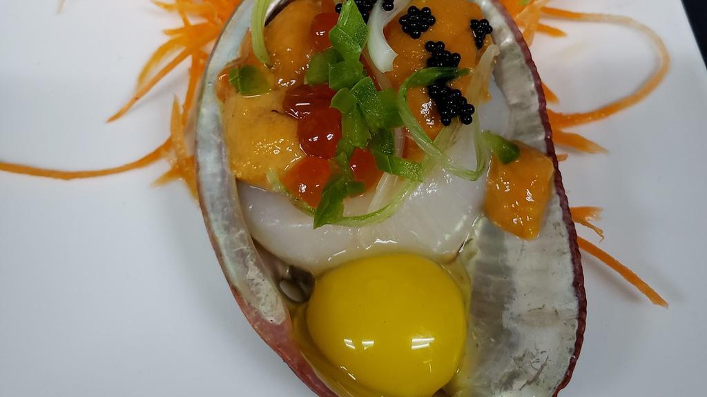 Uni Over Scallop Deluxe · 2 pieces of scallop topped w/ sea urchin, quail egg, salmon caviar, jalapeno, soy tobiko, scallions & ponzu sauce.