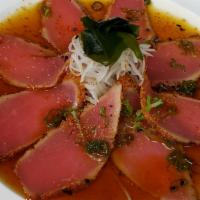 Pepper Tuna · House made peppered & seared tuna, over daikon. Topped w/ ponzu sauce & scallion.