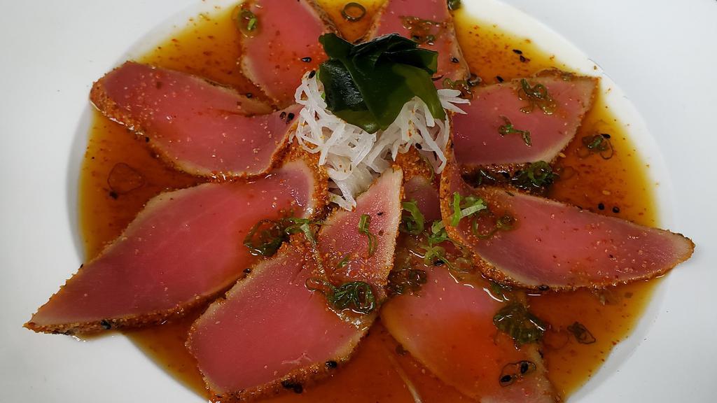 Pepper Tuna · House made peppered & seared tuna, over daikon. Topped w/ ponzu sauce & scallion.