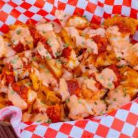 Loaded Fries · Waffle fries, melted cheese, fried chicken bits, chives, comeback sauce.