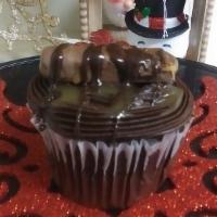 Twix Cupcake · Chocolate cupcake topped with chocolate icing, twix candy bar drizzled with premium milk cho...