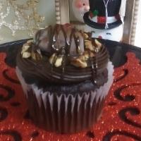 Turtle Cupcake · Chocolate cupcake topped with turtle candy nugget, drizzled with premium milk chocolate, car...
