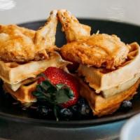 Chicken & Waffles · Savory marinated chicken tenders, deep fried and served on a fluffy Belgian waffle. Served w...