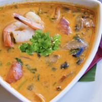 Tom Kha · An exotic spicy soup with coconut milk, mushrooms, tomatoes, cilantro, lemongrass, galangal ...