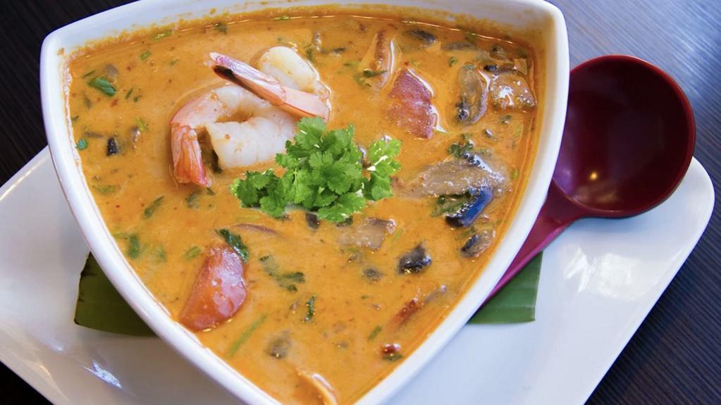 Tom Kha · An exotic spicy soup with coconut milk, mushrooms, tomatoes, cilantro, lemongrass, galangal roots and roasted chili