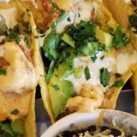 Dynamite Shrimp Tacos · Crispy shrimp toasted in our signature dynamite sauce on corn tortillas, shredded lettuce an...