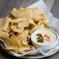 Regular Queso Blanco · Melted white cheese with green chiles and onions. Garnished with diced tomatoes and pickled ...
