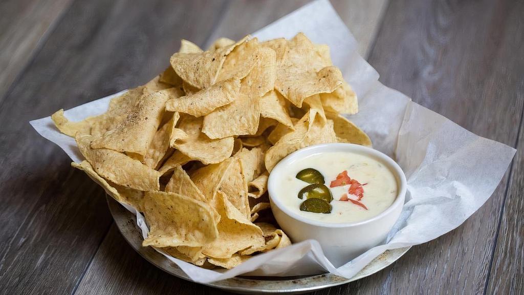 Regular Queso Blanco · Melted white cheese with green chiles and onions. Garnished with diced tomatoes and pickled jalapeños.. **please note that we cannot remove the onion and chiles**