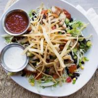 Grilled Chicken Taco Salad · Seasoned grilled chicken, black bean and corn pico, diced tomatoes, sour cream, and avocado ...