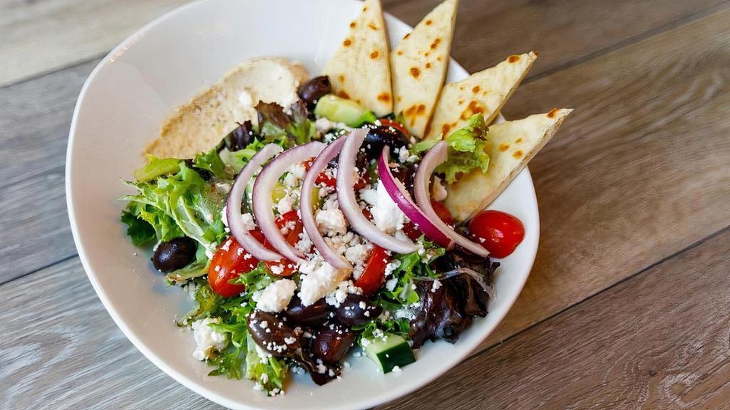 Greek Salad · Kalamata olives, red onions, cucumbers, cherry tomatoes and feta cheese on mixed greens topped with Aegean Vinaigrette and served with hummus and pita bread.