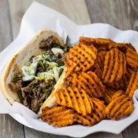 Texas Philly · Thinly Shaved beef sirloin or fajita chicken, Queso Blanco, caramelized onions and grilled p...