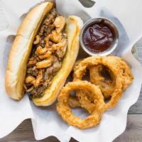 Pulled Pork Sandwich · House made pulled pork, jack cheese, and crispy onion strings served with a side of BBQ sauc...