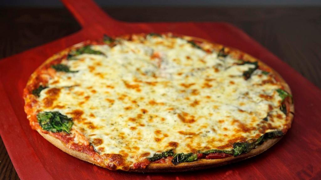 Spinach Classic Pizza · Zesty trio of spinach, fresh garlic and tomato.