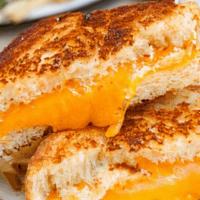 Grilled Cheese · Traditional grilled cheese sandwich served with French fries.