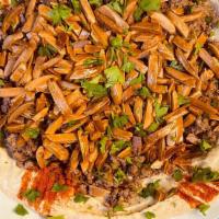 Hummus Topped Beef · A purée of ground chickpea made with tahini, garlic, and lemon topped with ground beef and s...