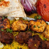 Mixed Tikka · Marinated beef and chicken skewers charbroiled for a smoky flavor set on top of a bed of bas...