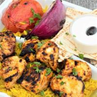 Chicken Tikka · Two marinated chicken skewers charbroiled for a smoky flavor set on top of a bed of basmati ...