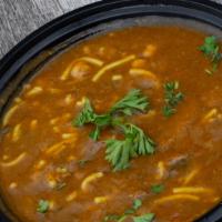 Harira · Traditional Moroccan soup made with tomatoes, lentil, chickpeas, fresh herbs and beef