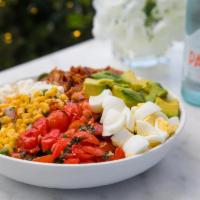 Cobb Salad · spring mix, hard boiled eggs, basil infused cherry tomatoes, avocado, bacon, feta, corn sala...