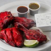 Tandoori Chicken · Chicken leg quarters marinated in fresh spices, herbs, yogurt, and barbecued over flaming ch...