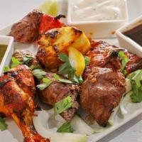 Mixed Grill · Tandoori chicken, reshmi kabab, lamb boti kabab, chicken tikka seasoned in Indian herbs, spi...