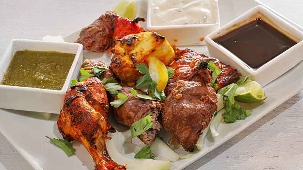 Mixed Grill · Tandoori chicken, reshmi kabab, lamb boti kabab, chicken tikka seasoned in Indian herbs, spices, and broiled in tandoor. Served with rice.
