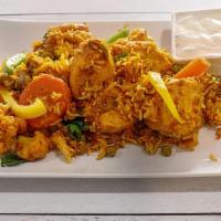 Chicken Biryani · Basmati rice cooked with chicken in savory Indian spices and garnished with nuts. Served wit...