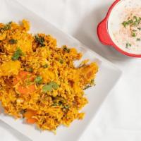 Vegeterian Biryani · Basmati rice cooked with vegetables and garnished with nuts. Served with raita.