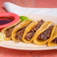 Tacos Tilaquepaque · Five barbeque tacos with a special, spicy sauce.  Comes with lemon wedges, red and green sau...