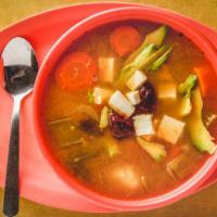 Caldo Tlalpeño · Tasty chicken soup with rice, cheese, avocado, chickpeas, and a chipotle pepper on the side....