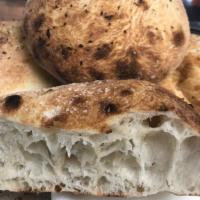 Schiaccata · A loaf of our stone-oven baked bread topped with either a garlic parmesan or rosemary infuse...