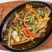 Oven Baked Tilapia In Cast Iron · With choice of side.