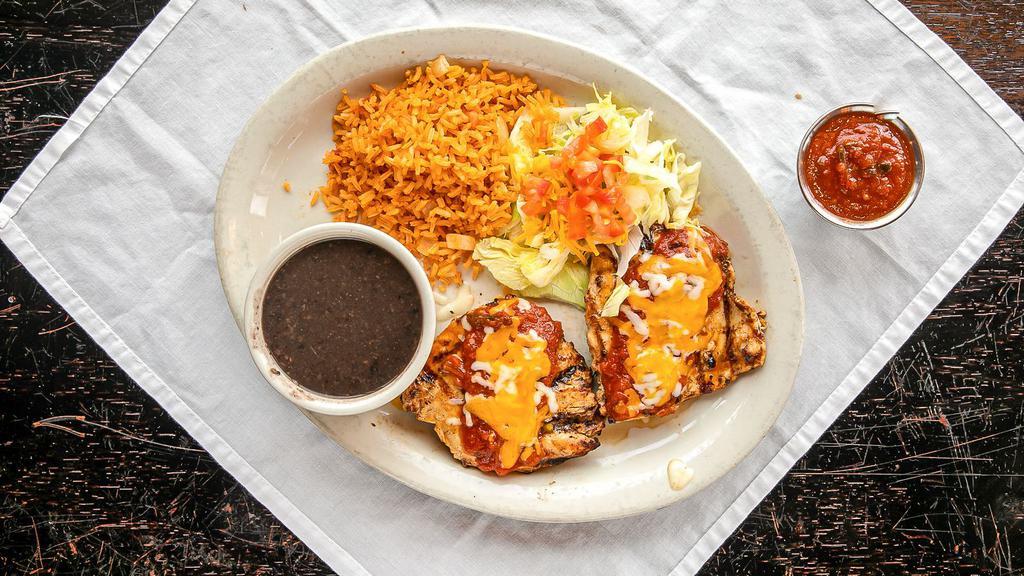 Chicken Monterrey · Marinate, grilled, and boneless chicken breast topped with ranchero sauce and melted Monterey cheese. Served with a house side salad.