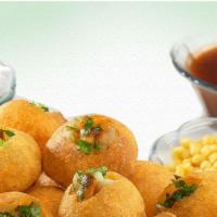 Pani Puri · Round fried hallow puris with filling of chickpeas, boiled potatoes, chutney & onion served ...