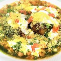 Aloo Tikki Chaat · Small cutlet made of boiled potatoes, onions & various spices, served with yogurt & chutneys.