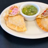 Empanadas De Jamón Y Queso Y Picadillo · Homemade empanadas straight from river plate one containing ham, cheese, and the other conta...