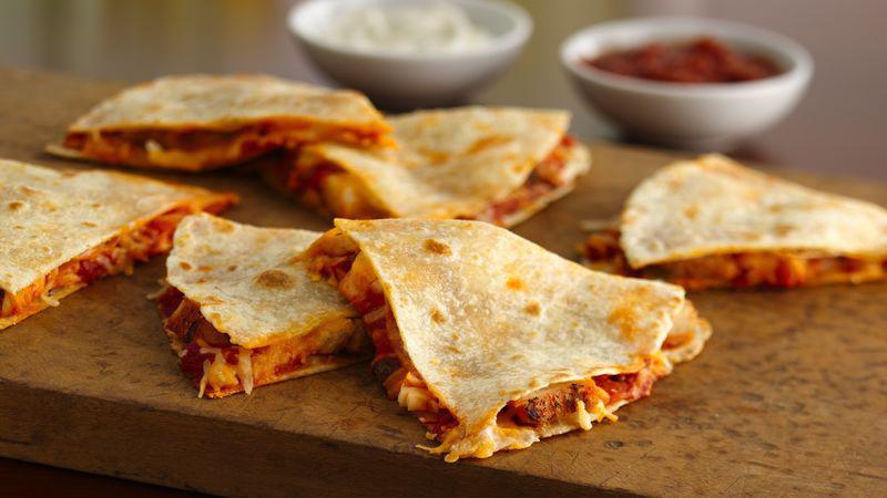 Quesadillas · Grilled flour tortillas stuffed with shredded monterey jack, Cheddar cheeses, poblano peppers, caramelized onions, and fajita chicken or fajita beef. Served with pico de gallo, jalapeños, guacamole and sour cream.