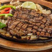 Beef Fajita · Served sizzling hot on a bed of sauteed onions and bell peppers, with refried beans, Mexican...