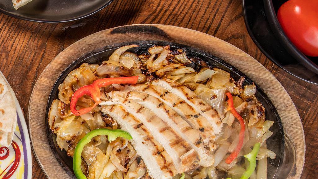 Chicken Fajita · Served sizzling hot on a bed of sauteed onions and bell peppers, with refried beans, Mexican rice, flour tortillas, sour cream pico de gallo, and choice of cheese or guacamole.