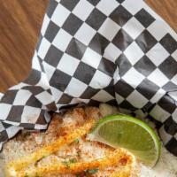 Classic Elotes · Grilled corn topped with mayonnaise, cotija cheese, dusted with red chile powder and served ...