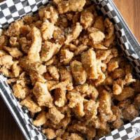 Popcorn Chicken Family Pack · Crispy hand battered chicken bites tossed in one signature house-made sauce of your choice (...