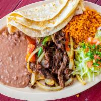 Beef Fajita Dinner Plate · Cooked with grilled onions and bell peppers served with rice, refried beans, salad, and tort...