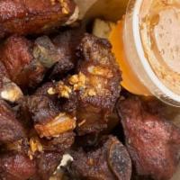 Pork Riblets · Deep fried short riblet (pork)garnished with fried garlic flakes and served with sweet and t...
