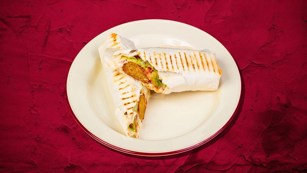 Falafel Wrap Sandwich Funky · Falafel wrapped in tortilla bread, potato, pickles, salad, and tahini sauce.