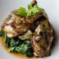 Pan Seared Chicken · Half of a roasted chicken served with pan drippings.