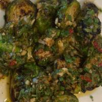 Grilled Brussels Sprouts · Grilled Brussels sprouts, halved and skewered, topped with chermoula