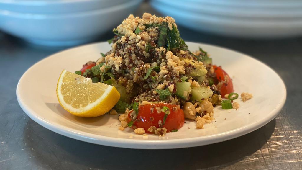 Quinoa Salad · Mixture of red and white quinoa, campari tomatoes, marcona almonds, garbanzo beans, cucumber, raisin medley, mint, basil, and green onions tossed in a shallot vinaigrette dressing