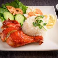 Viet'S Style Fried Chicken · Quarter leg chicken deep-fried served with white rice ,cucumber, tomato, & lettuce, picked c...